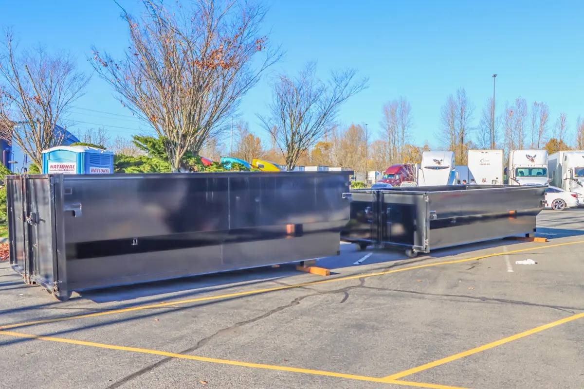 Professional dumpster rental service with roll-off container on residential driveway in Credit River